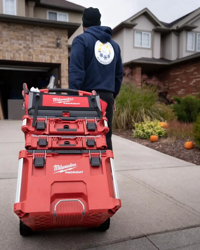 Total Aire Care technician with a toolbox approaching a home 