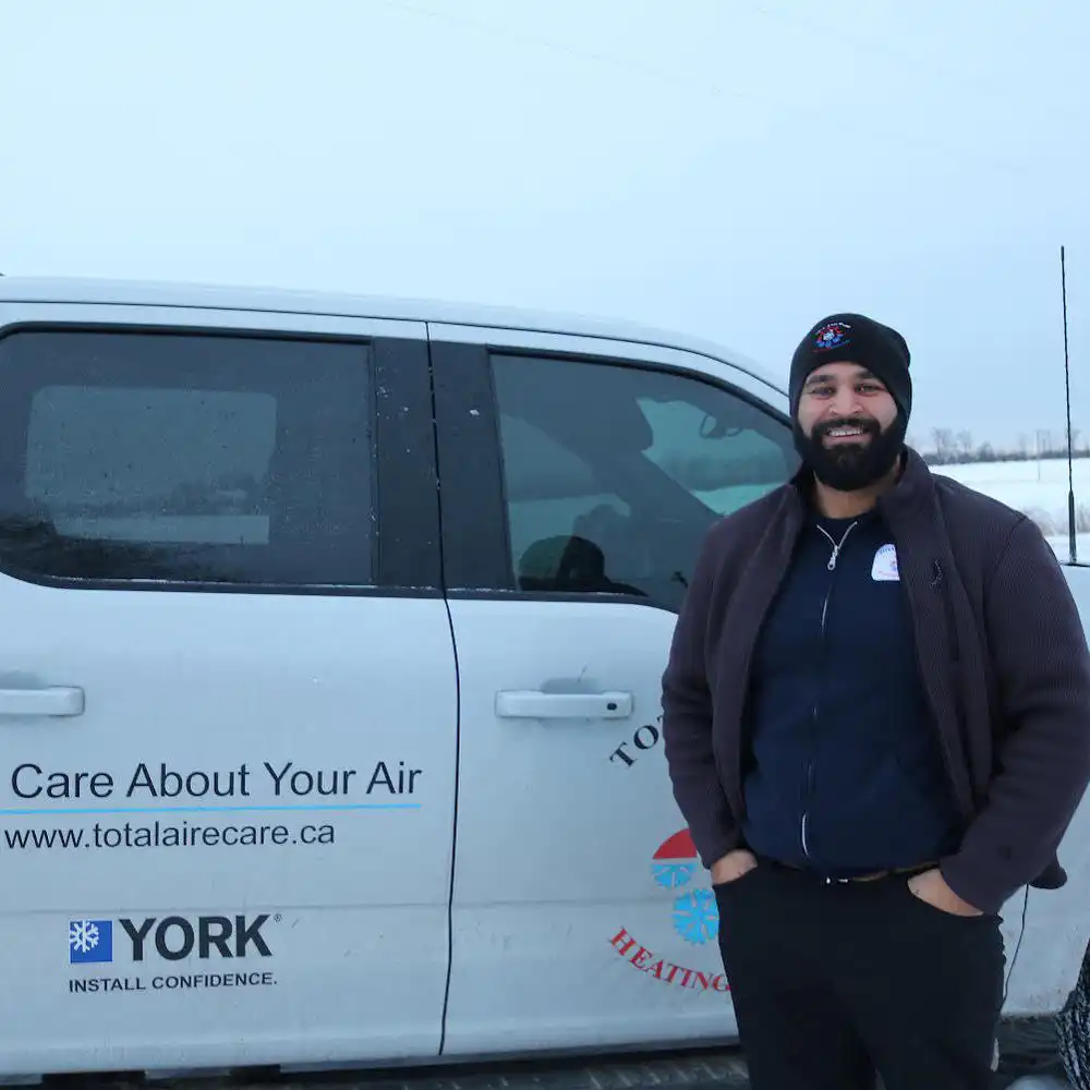 Gurveeri n front of a Total Aire Care truck